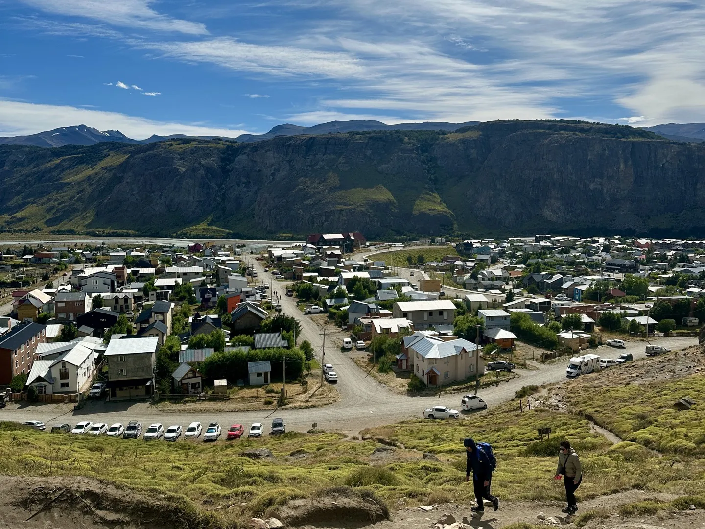 Two hikers on the first climb above El Chaltén, looking back over the town and the valley