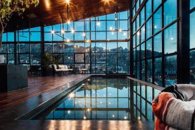 Rooftop pool at Atix hotel looking out over La Paz at dusk