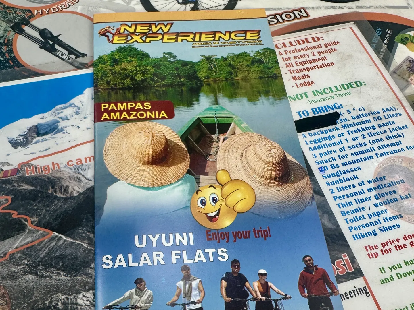 Tour brochures on an agency desk in La Paz, one listing what is included and what to bring