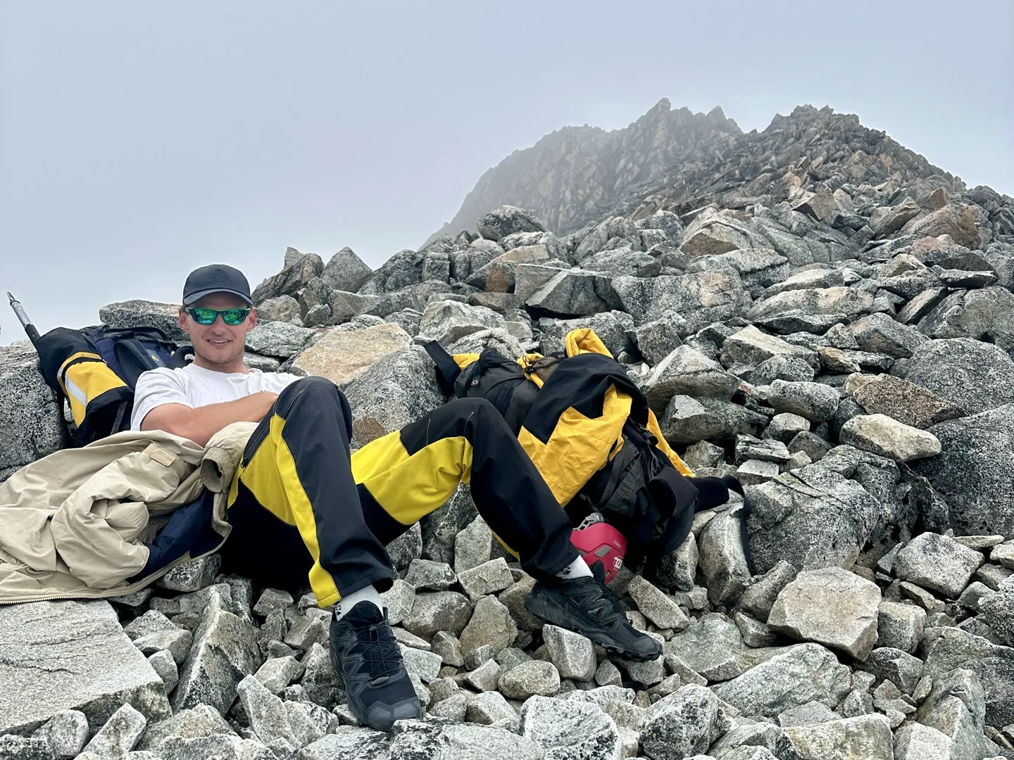 A climber resting on the boulders on the climb to high camp on Huayna Potosi