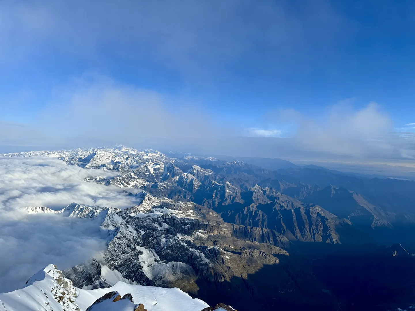 The view from the 6,088 m summit of Huayna Potosi, ranges and cloud stretching to the horizon