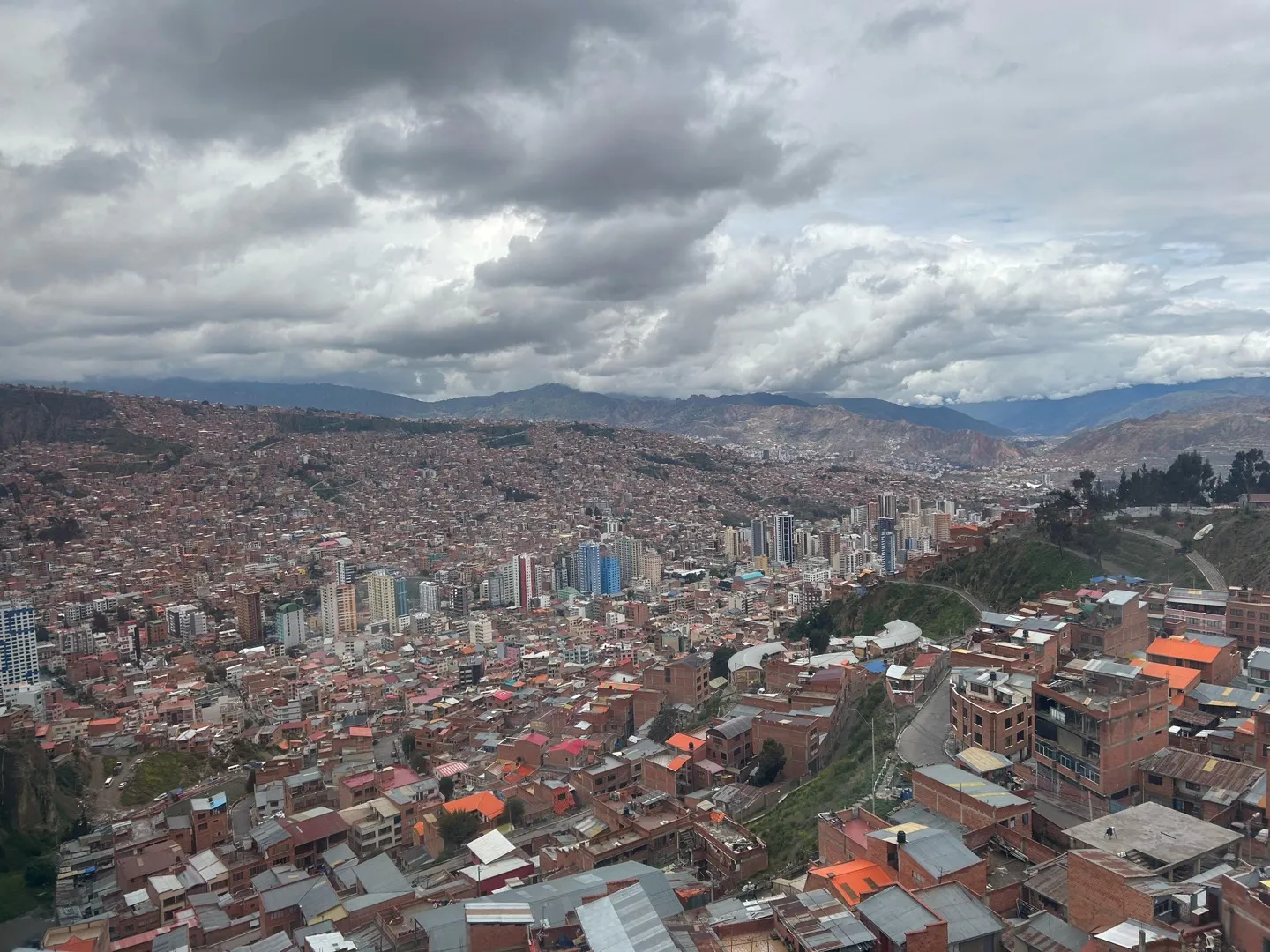 Red-brick houses of La Paz spreading up the valley slopes under heavy cloud