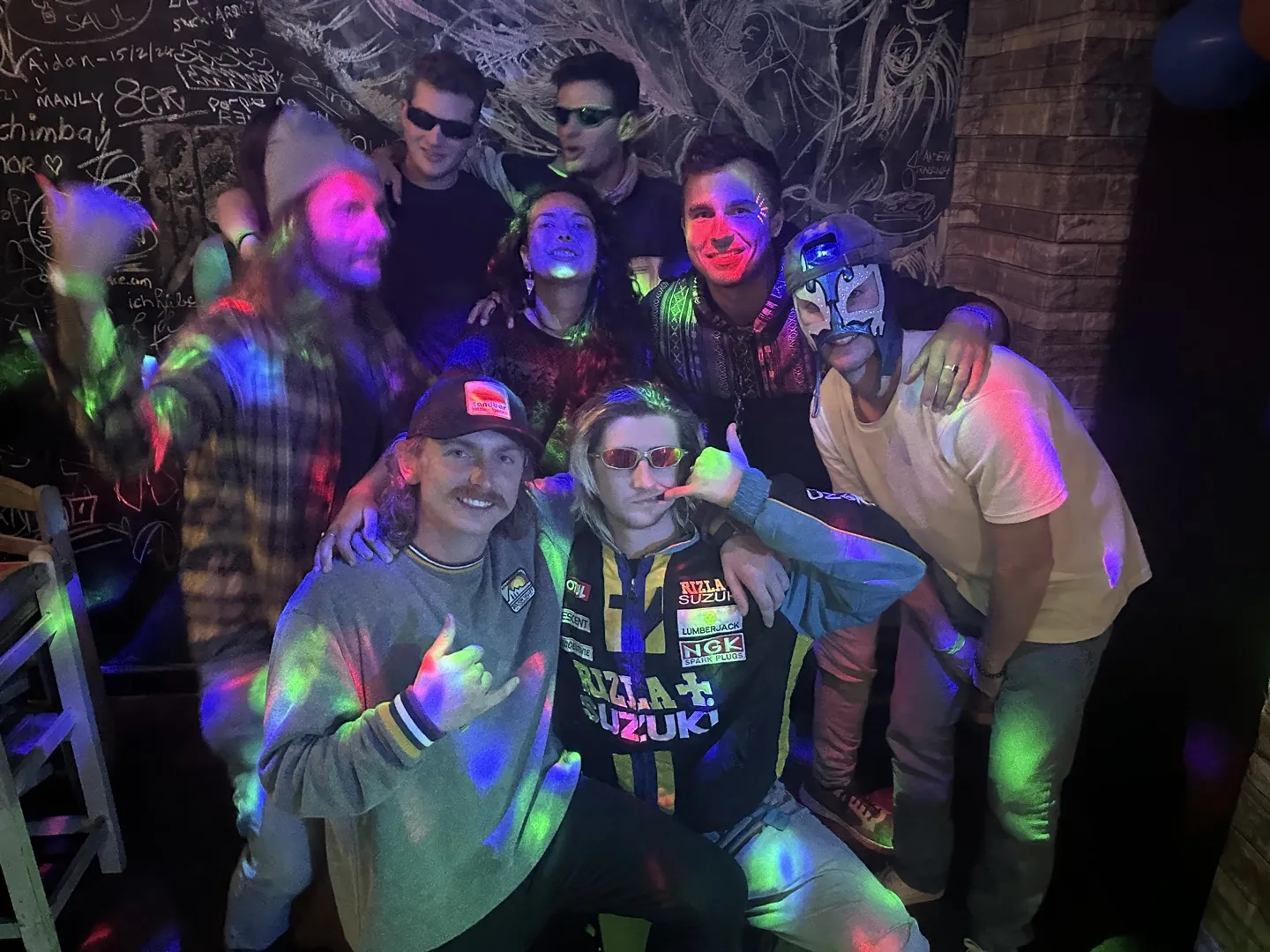 Our group lit by coloured lights inside Route 36, the one photo the staff let us take