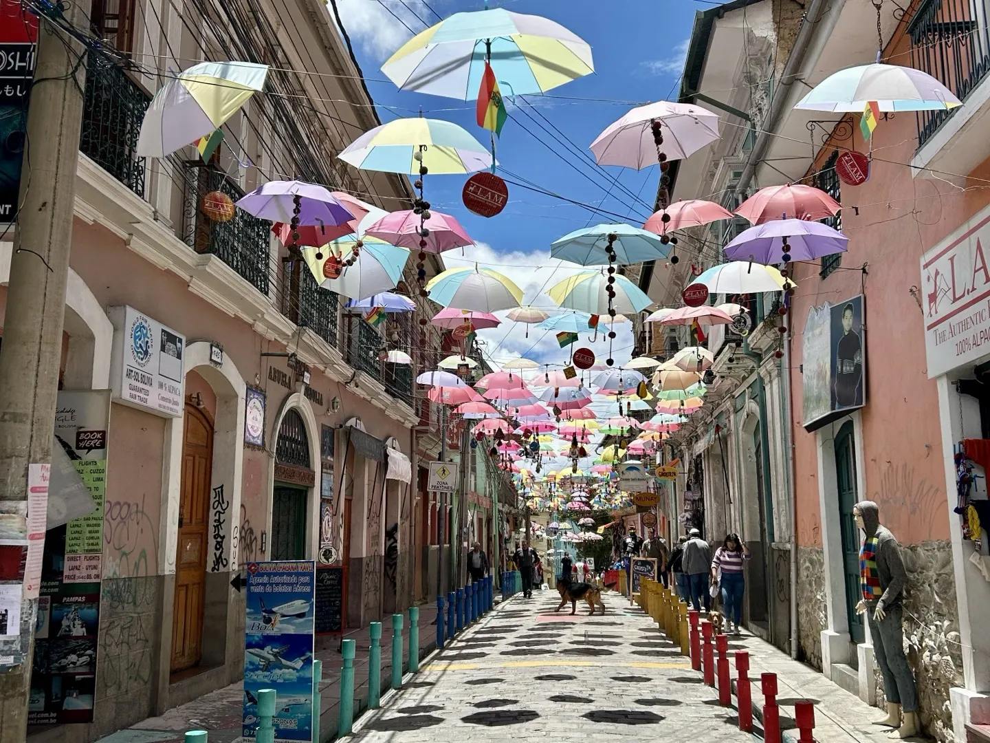 Umbrellas hanging over a colonial street in central La Paz on a clear day