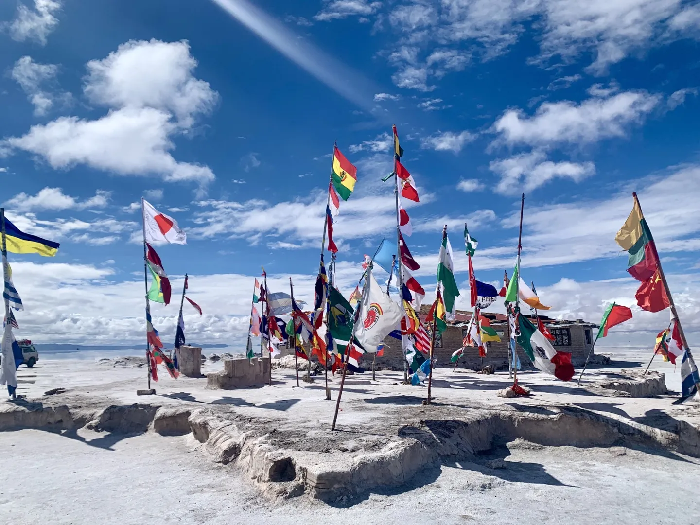 Flags from around the world flying beside the old Playa Blanca salt hotel on the Salar de Uyuni