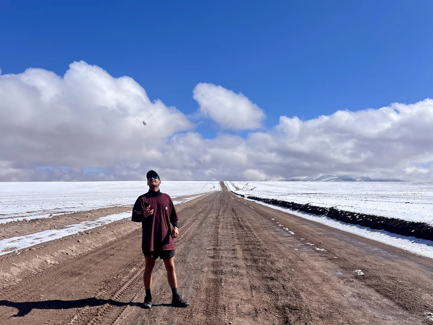 Standing on the dirt road out of Quetena Chico with fresh snow covering the altiplano on both sides