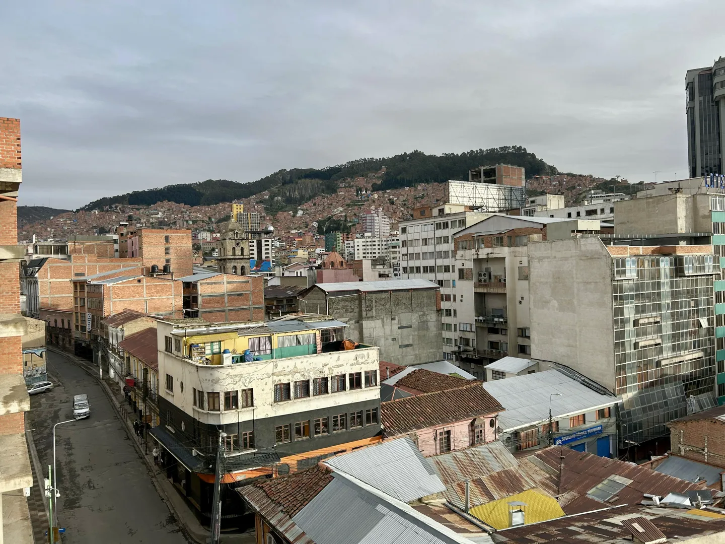 Corrugated rooftops and unfinished brick buildings climbing the slopes above central La Paz