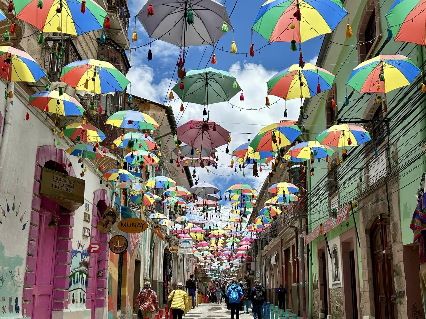 Hundreds of coloured umbrellas strung above a narrow shopping street in central La Paz