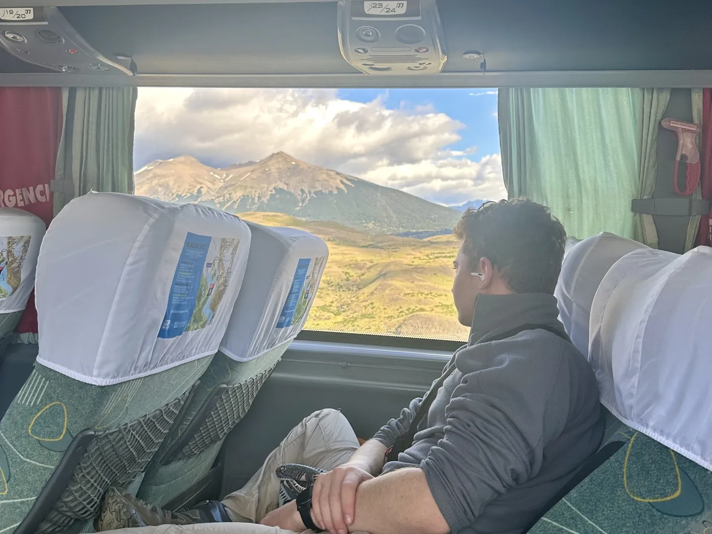 Looking out of the bus window at the mountains on the road from Puerto Natales to Torres del Paine