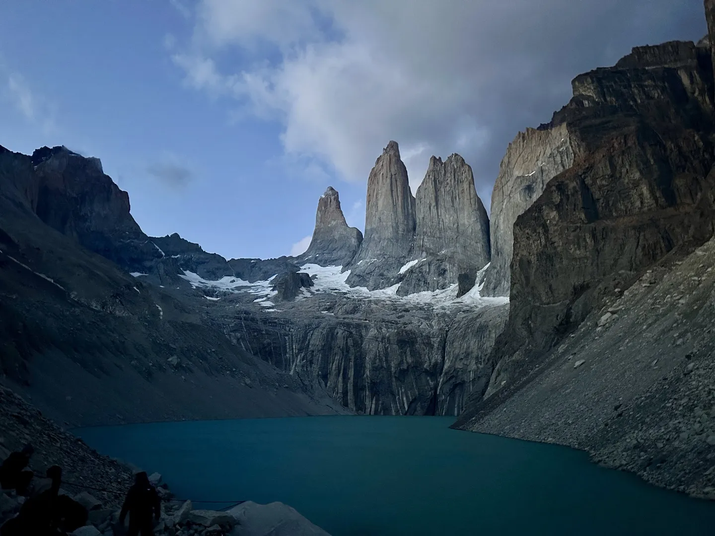 The three granite towers of Torres del Paine above the lake at Mirador Base Torres before sunrise