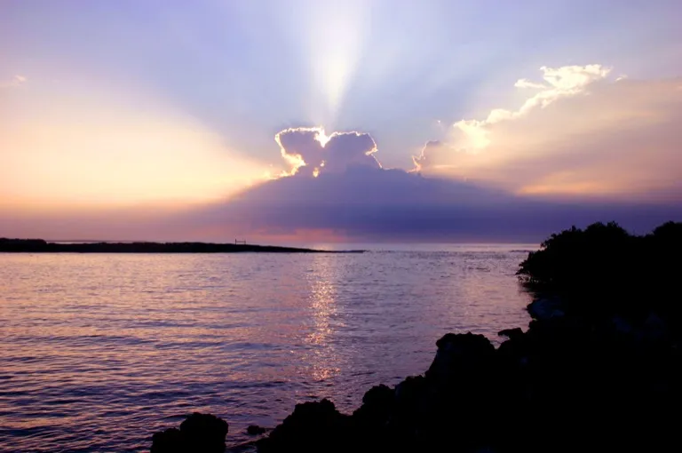 Sunset over the water off Las Tintoreras, near Puerto Villamil