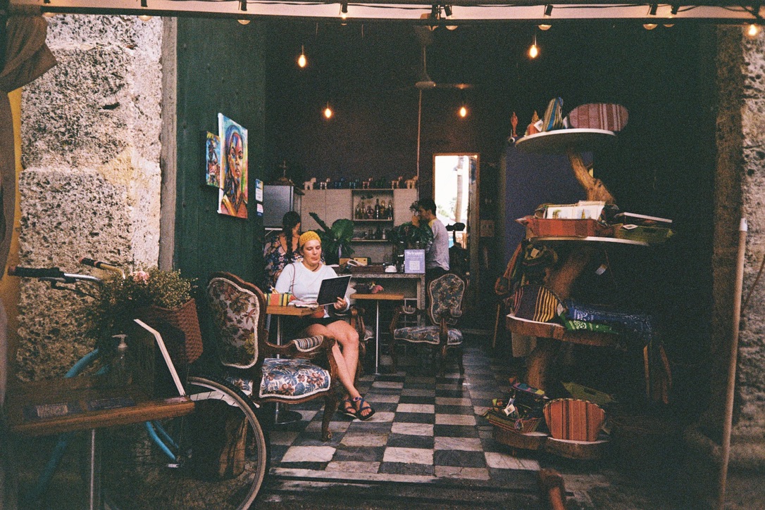 Woman reading inside a warmly lit café