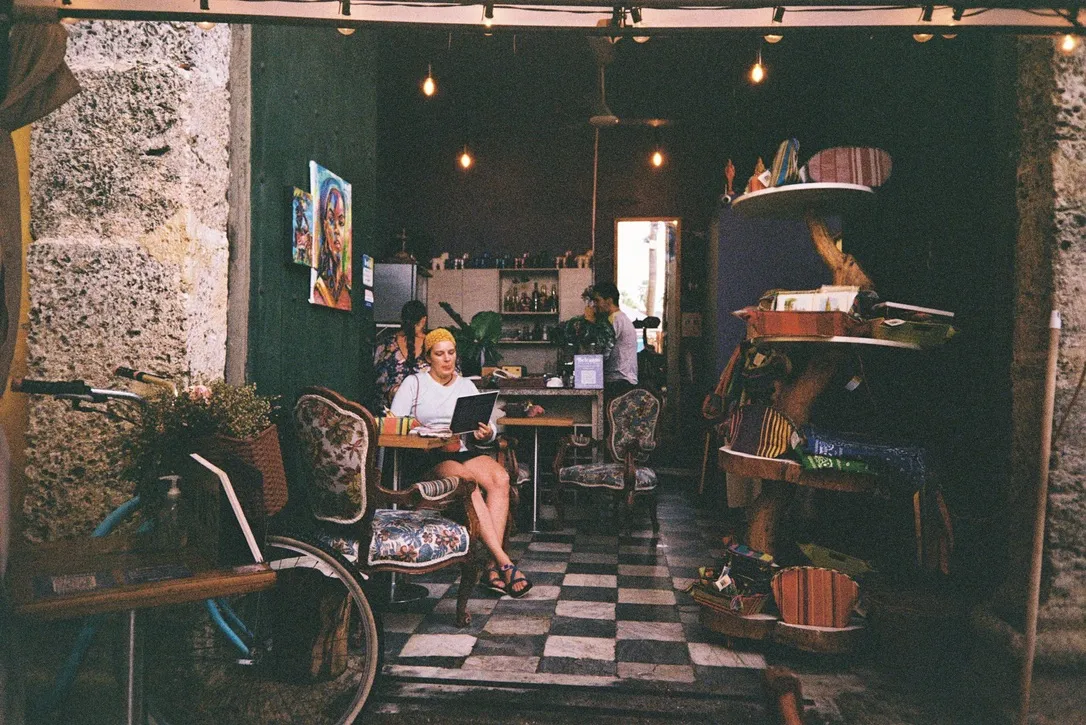 Woman reading inside a warmly lit café