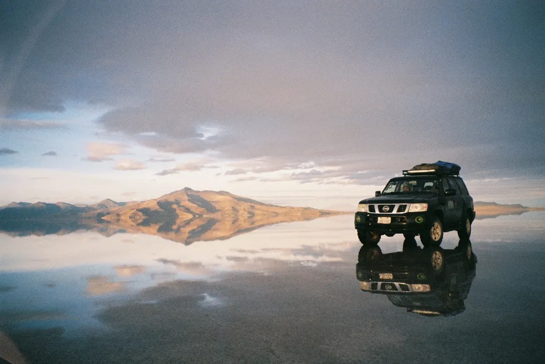 4WD reflected in the flooded Salar de Uyuni, Bolivia