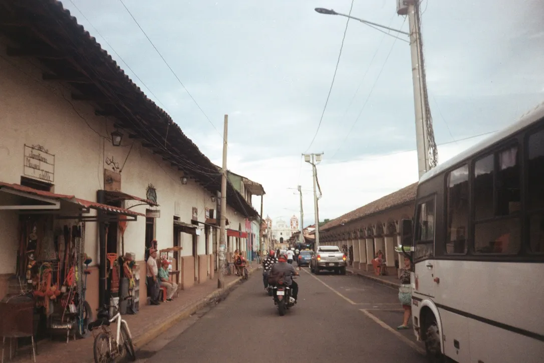 Street scene in a Central American town with a church in the distance