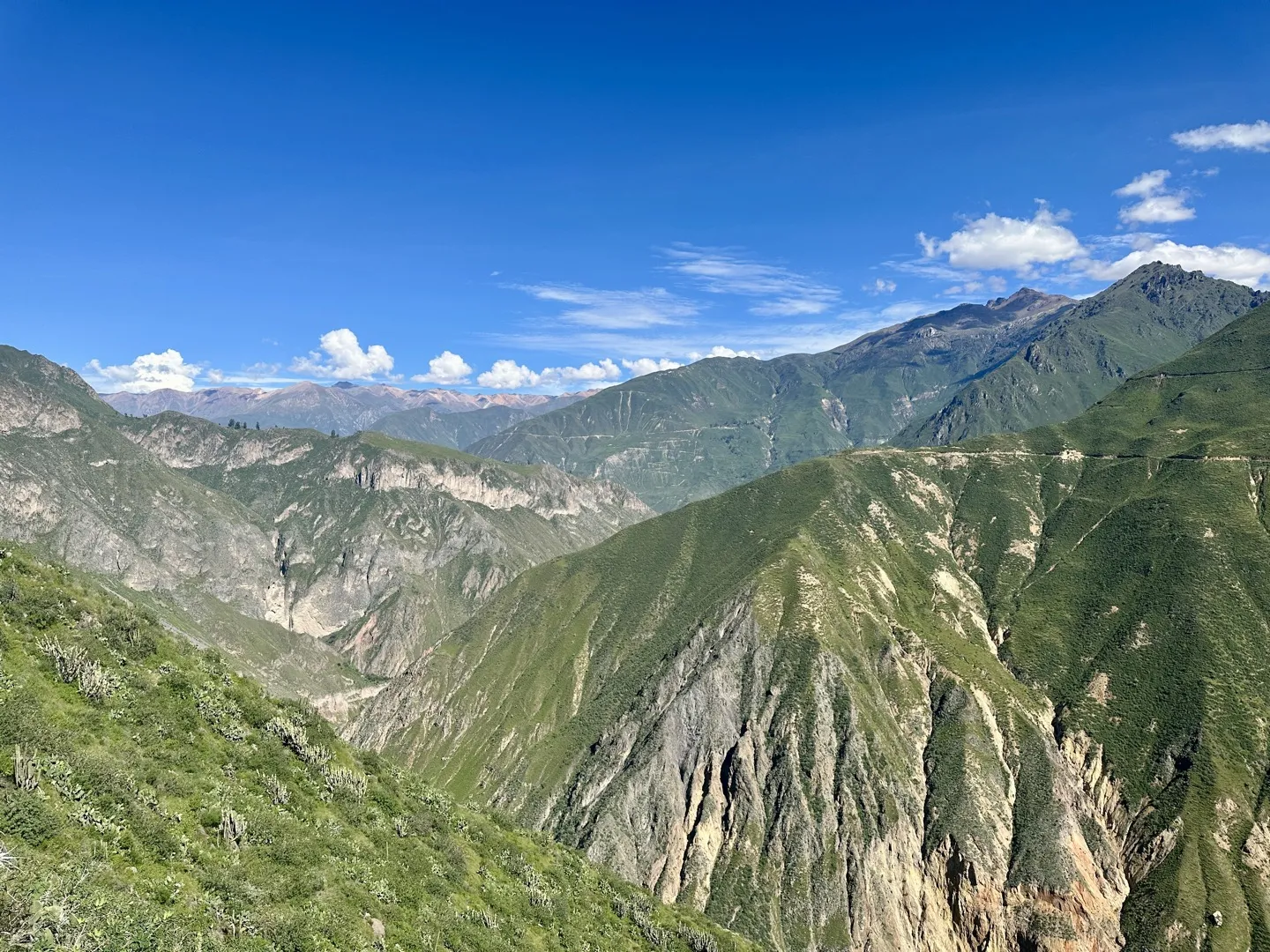 Panoramic view across the green ridges of the Colca Canyon