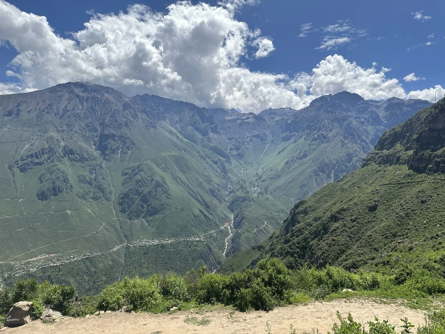 View over the Colca Canyon with a village far below seen from near the rim