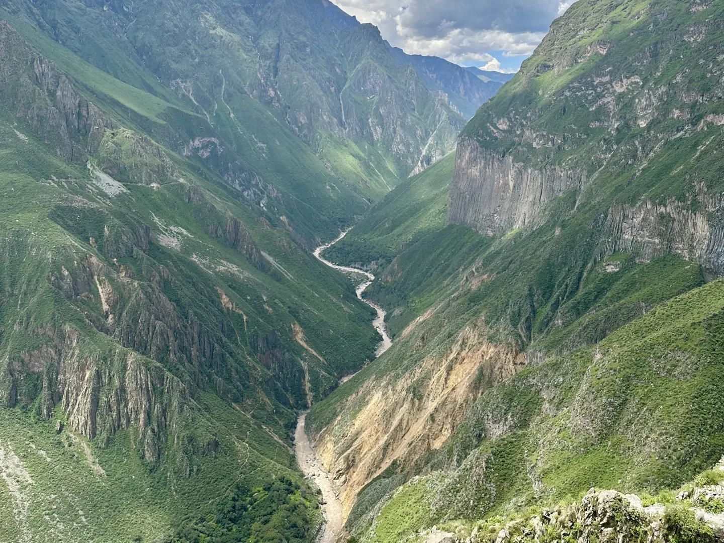 View down into the Colca Canyon with the river winding along the canyon floor, one of the best views on the Colca Canyon trek