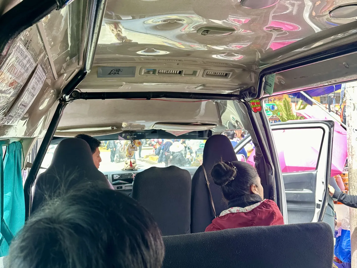 Inside the colectivo minivan from Huaraz to the Pitec trailhead, passengers seated ahead of the open side door