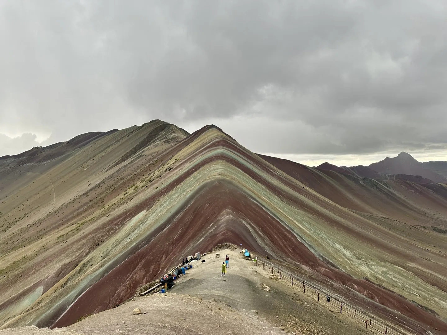 Hikers on the ridge at the main Rainbow Mountain viewpoint, Vinicunca, Peru