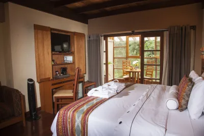 River-view suite with king bed and sitting nook at Casa del Sol Machupicchu, Aguas Calientes